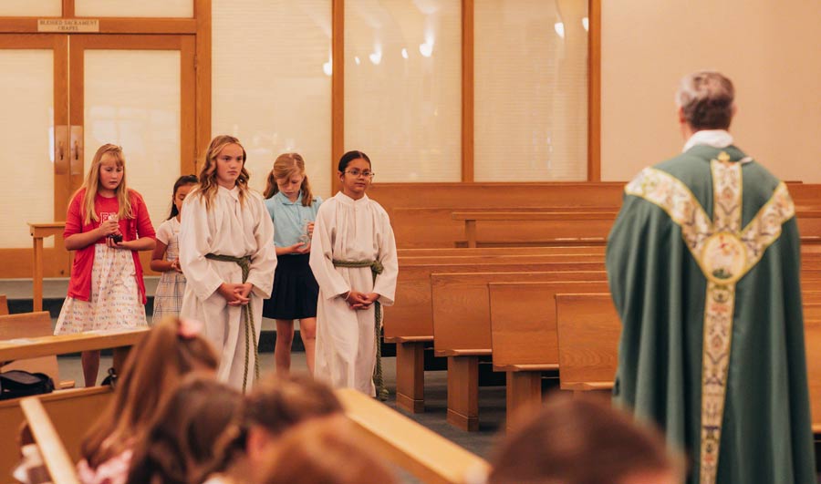 Catholic girl students at SJV catholic school carrying gifts