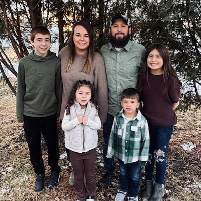 Family photo of Weiss family taken outdoors